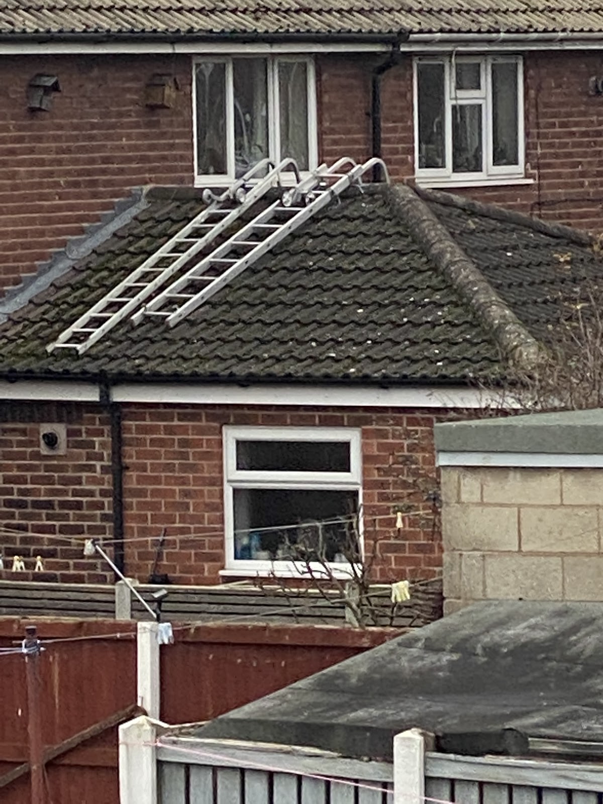Roof ladder set up on a tiled roof