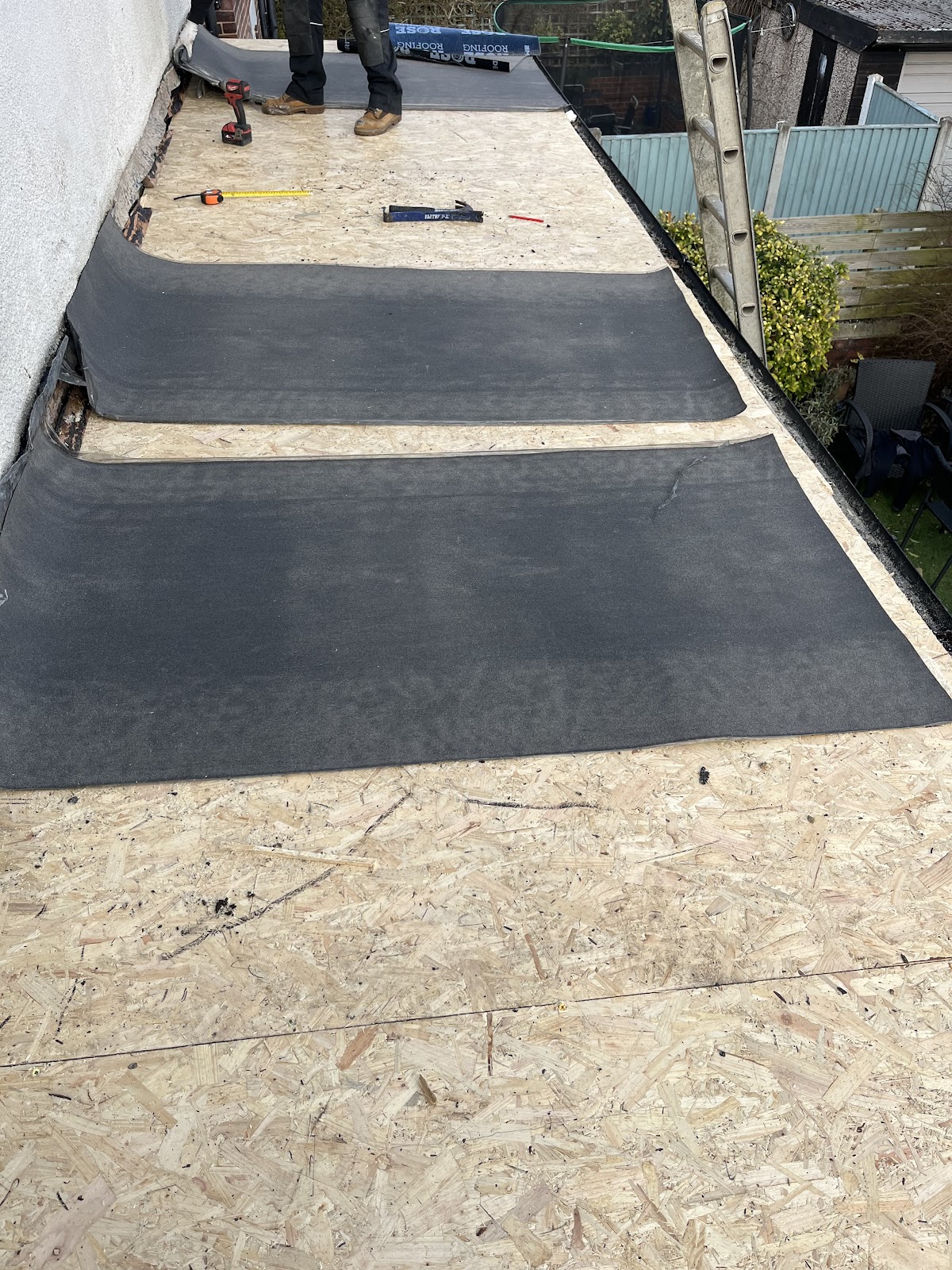 Torch-on felt being laid to a flat roof